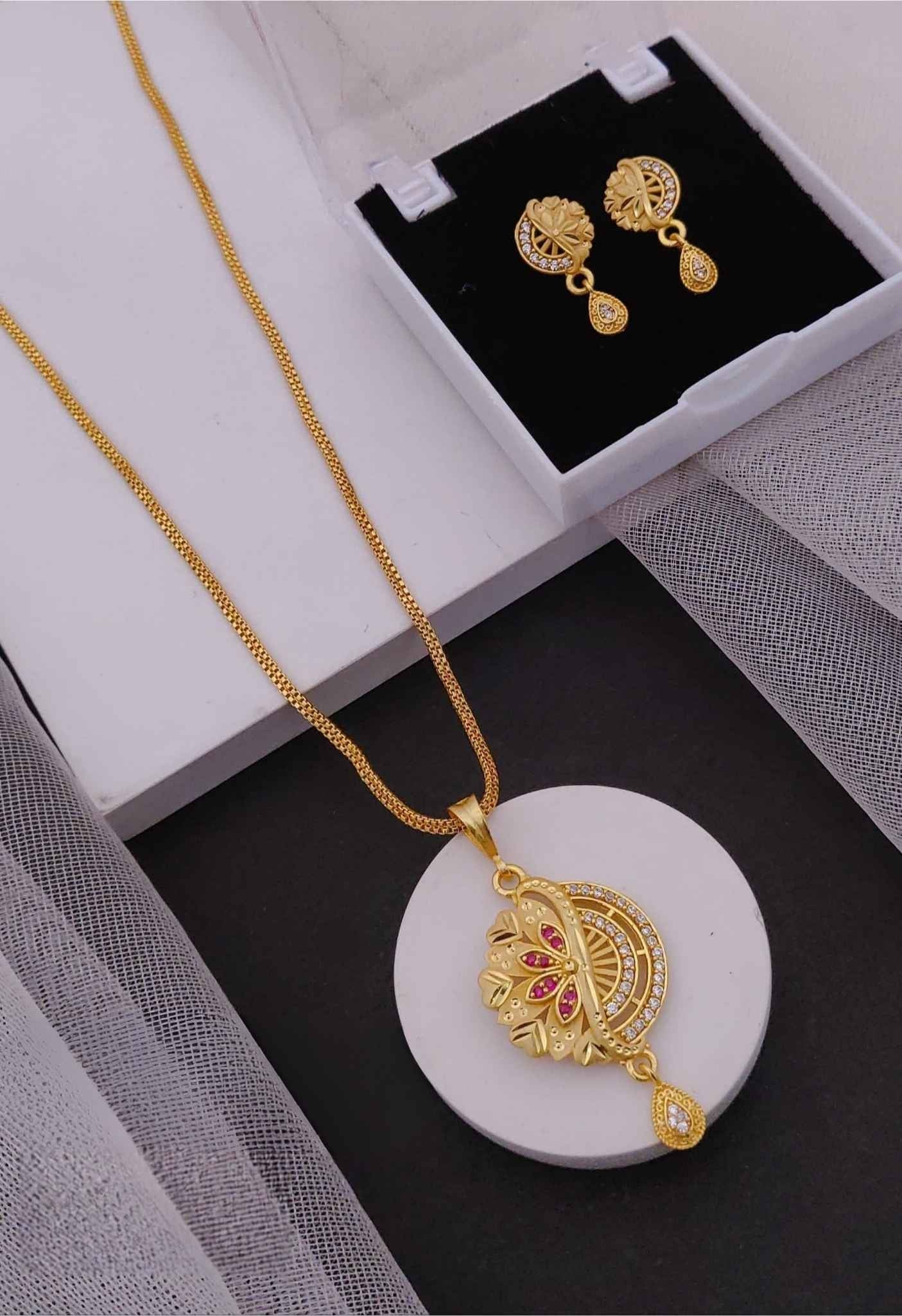 Elegant Gold Floral Pendant Set with Red Stones and Teardrop Earrings